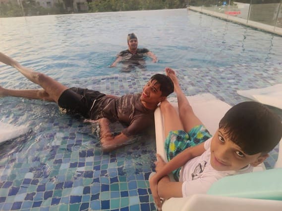 Fun at the swimming pool — water splashes, bright smiles, carefree energy